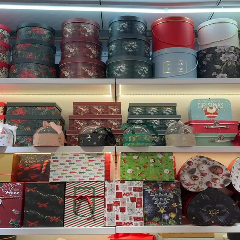 Assorted round, square, та heart-shaped decorative та Christmas gift boxes on shelves